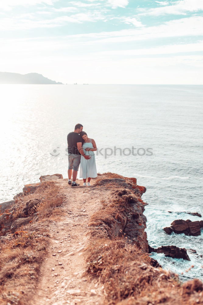 Similar – Person on cliff taking photo