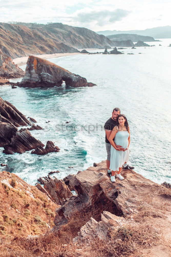 Similar – Image, Stock Photo Men standing on cliff at ocean