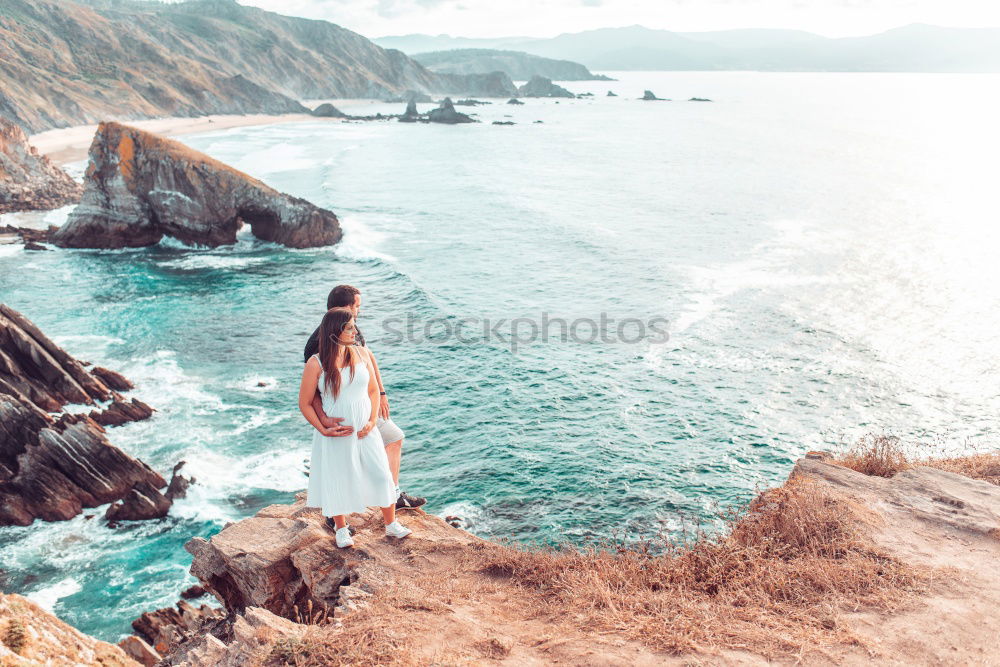 Similar – Woman sitting on stone at lake