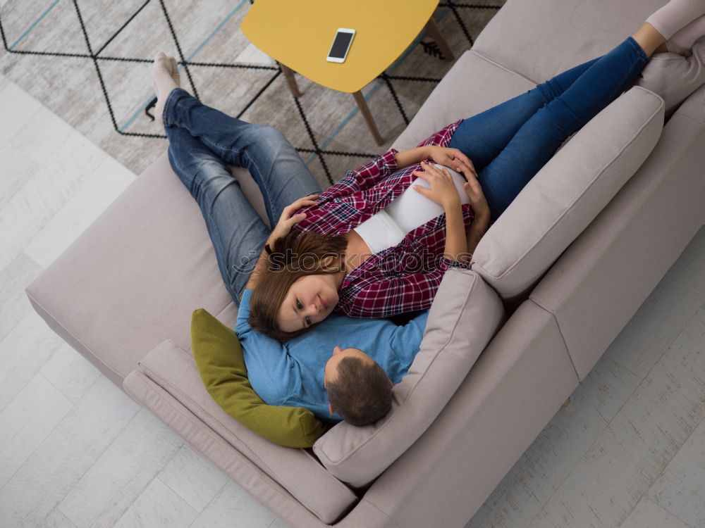 Similar – Image, Stock Photo Young woman sits on the couch and stretches out her long legs