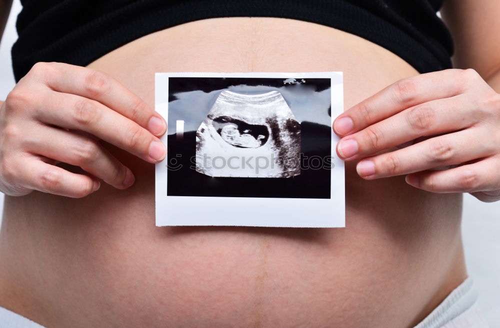 Similar – Image, Stock Photo pregnant woman sitting on the bench and loocking ultrasound scan at the day time. Concept of happy expectation.