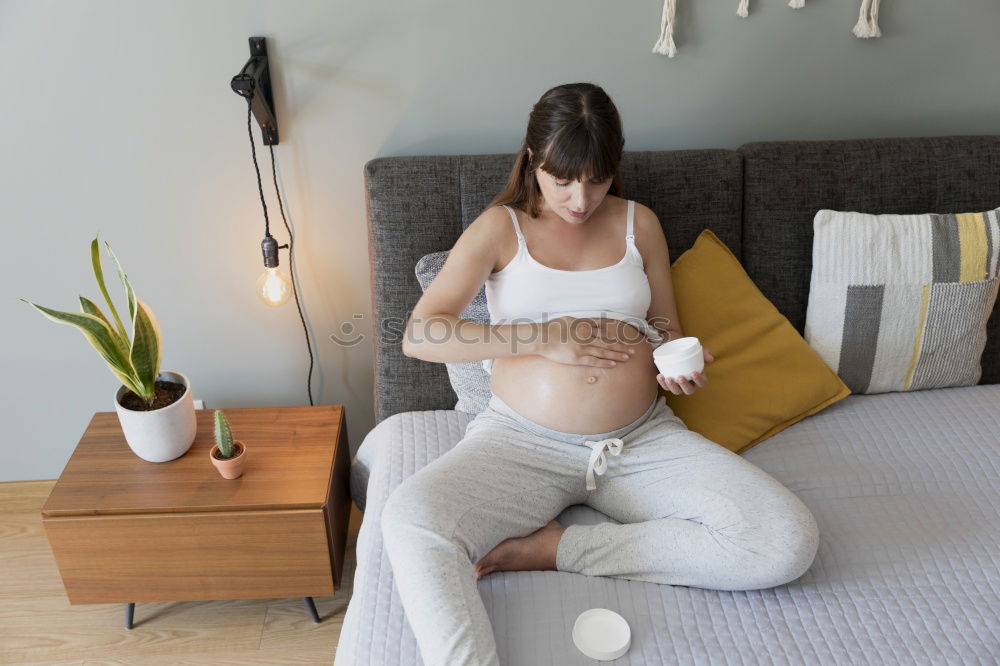 Similar – Pregnant woman touching her belly