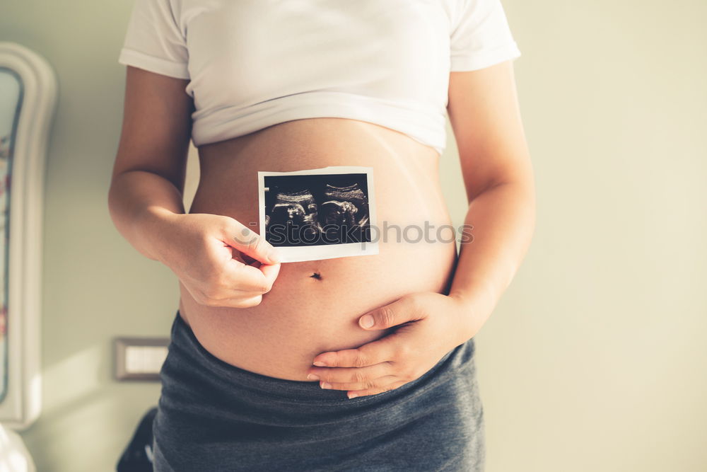 Similar – Image, Stock Photo pregnant woman sitting on the bench and loocking ultrasound scan at the day time. Concept of happy expectation.