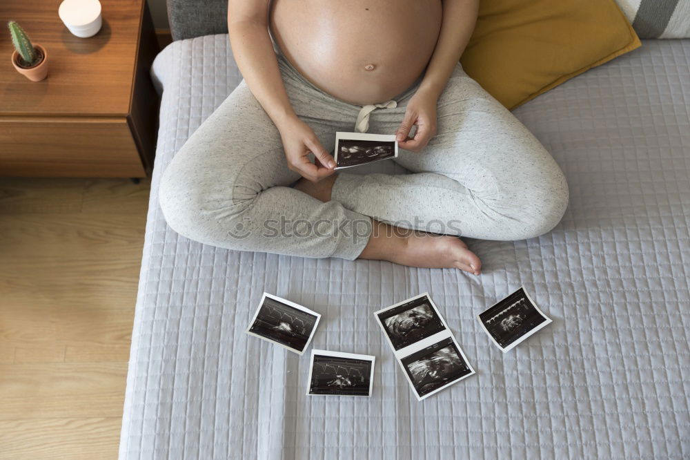 Similar – Image, Stock Photo pregnant woman sitting on the bench and loocking ultrasound scan at the day time. Concept of happy expectation.