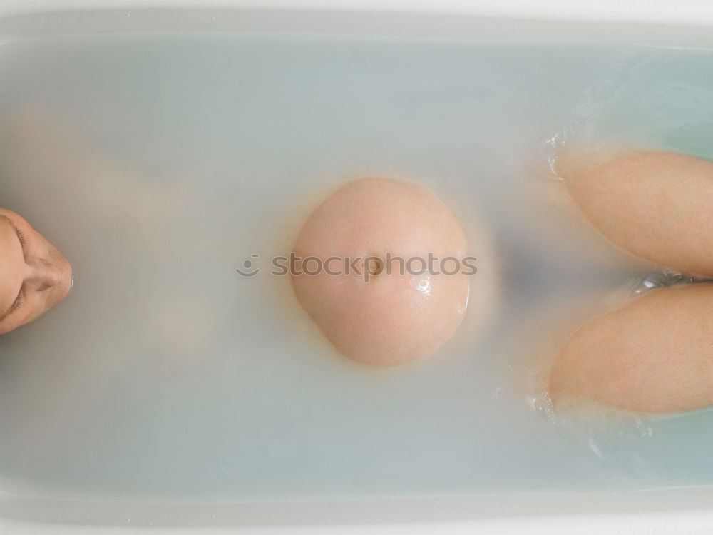 Similar – Long legs of a woman is the main subject of this image. She is relaxing in a milk bath with her red avant-garde shoes on. Golden cards and golden crane accompany her with these high fashion shoes.