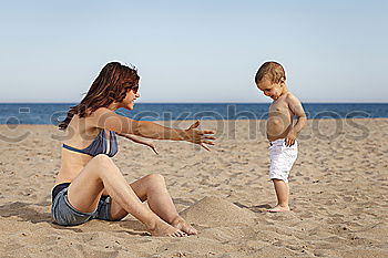 Similar – Image, Stock Photo caucasian mother and son playing with windmill at the beach