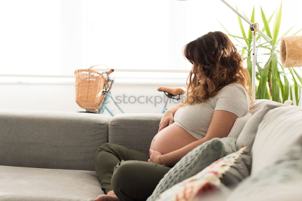 Pregnant woman touching her belly