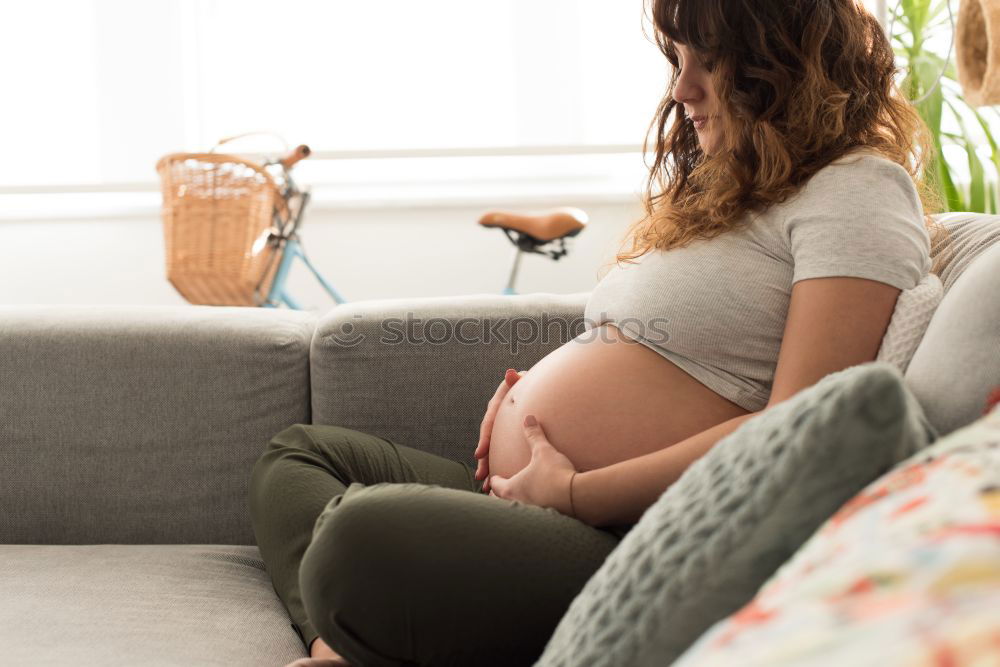 Similar – Pregnant woman touching her belly