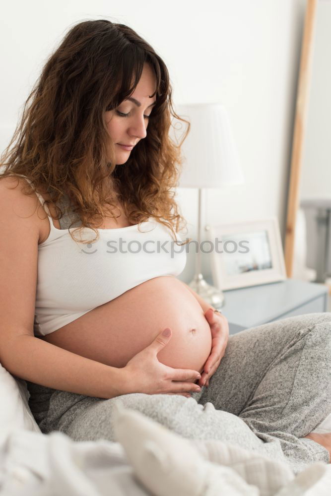 Similar – Pregnant woman touching her belly