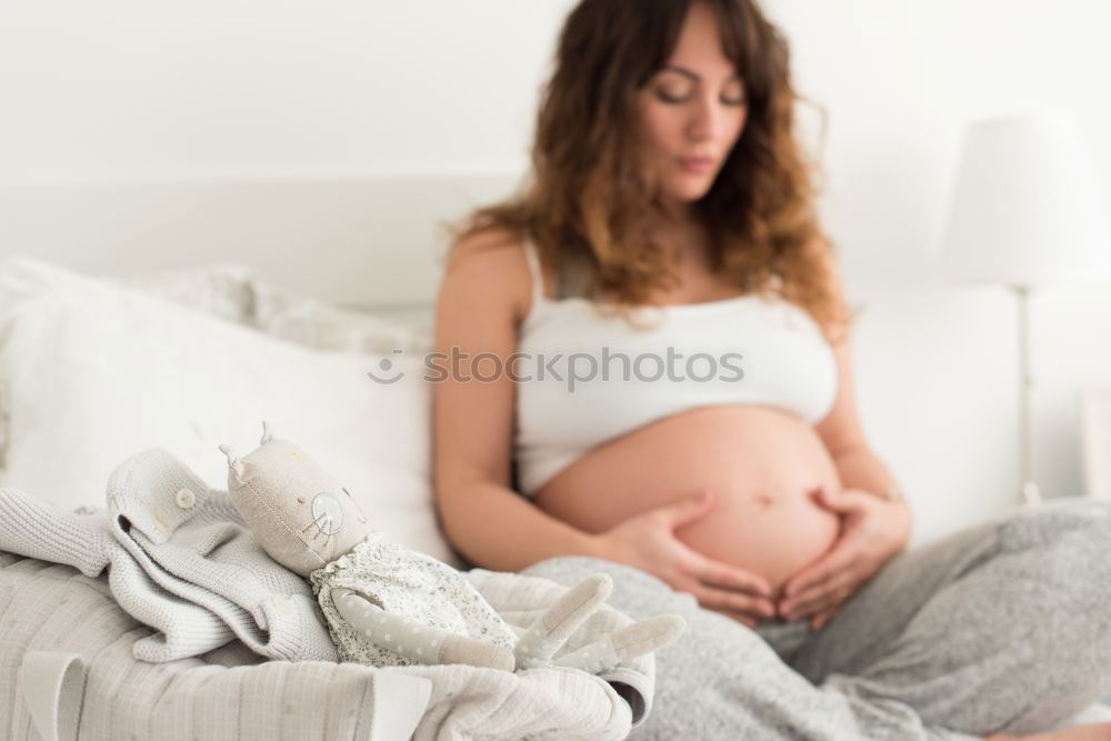 Similar – Pregnant woman touching her belly