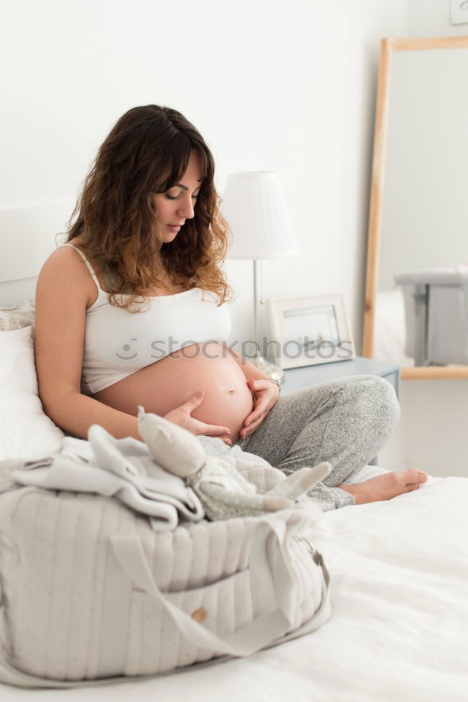 Similar – Pregnant woman touching her belly