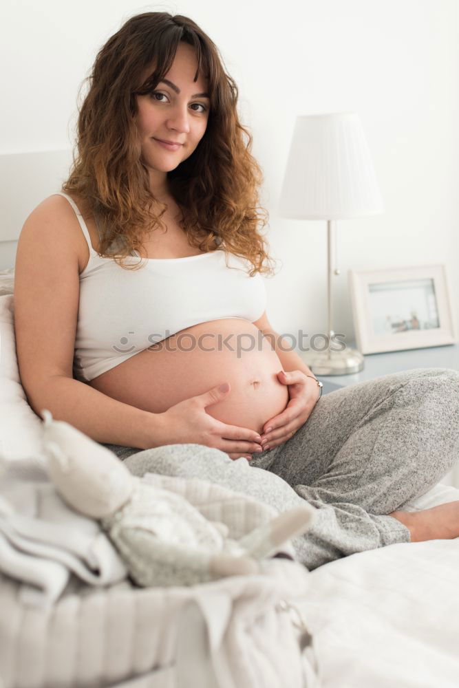 Pregnant woman touching her belly