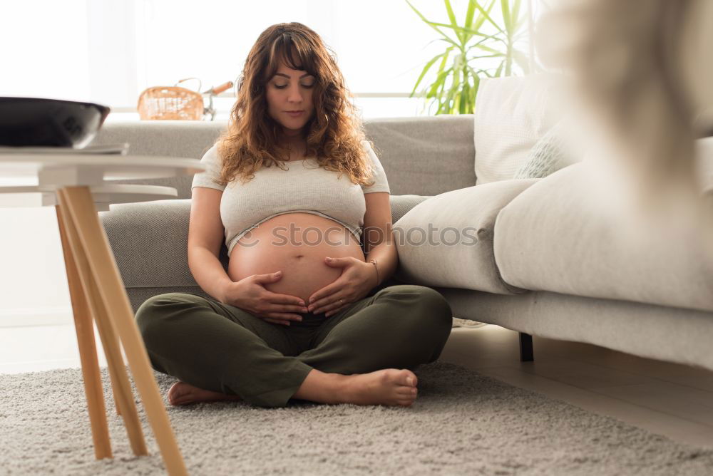 Similar – Pregnant woman touching her belly