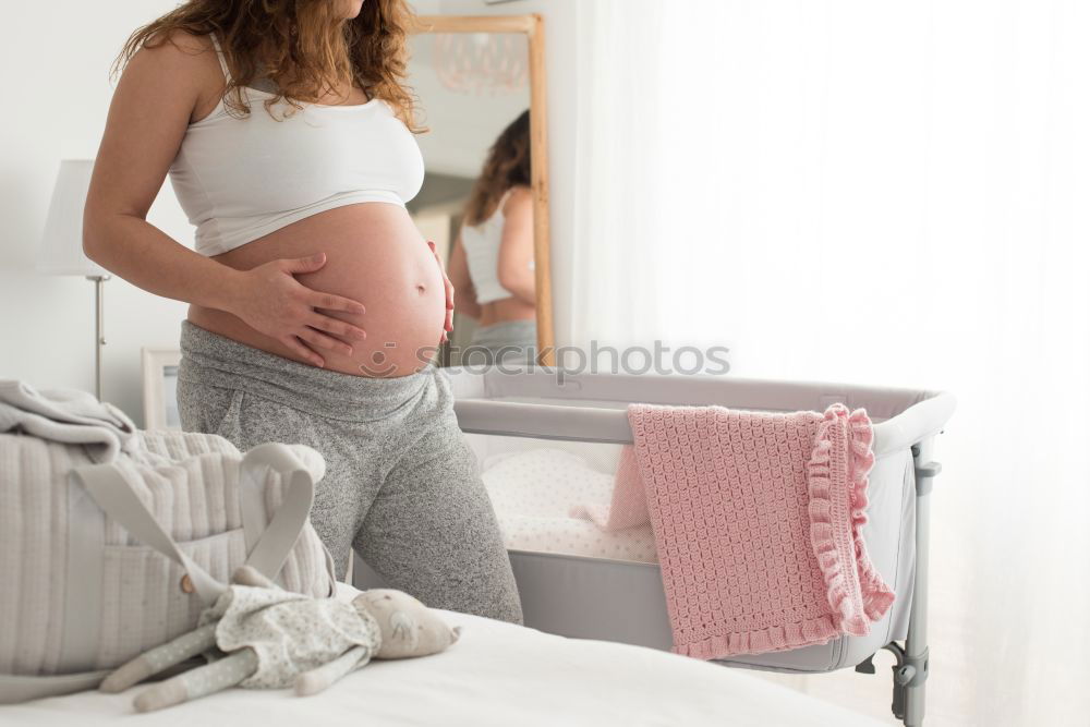 Similar – Pregnant woman touching her belly