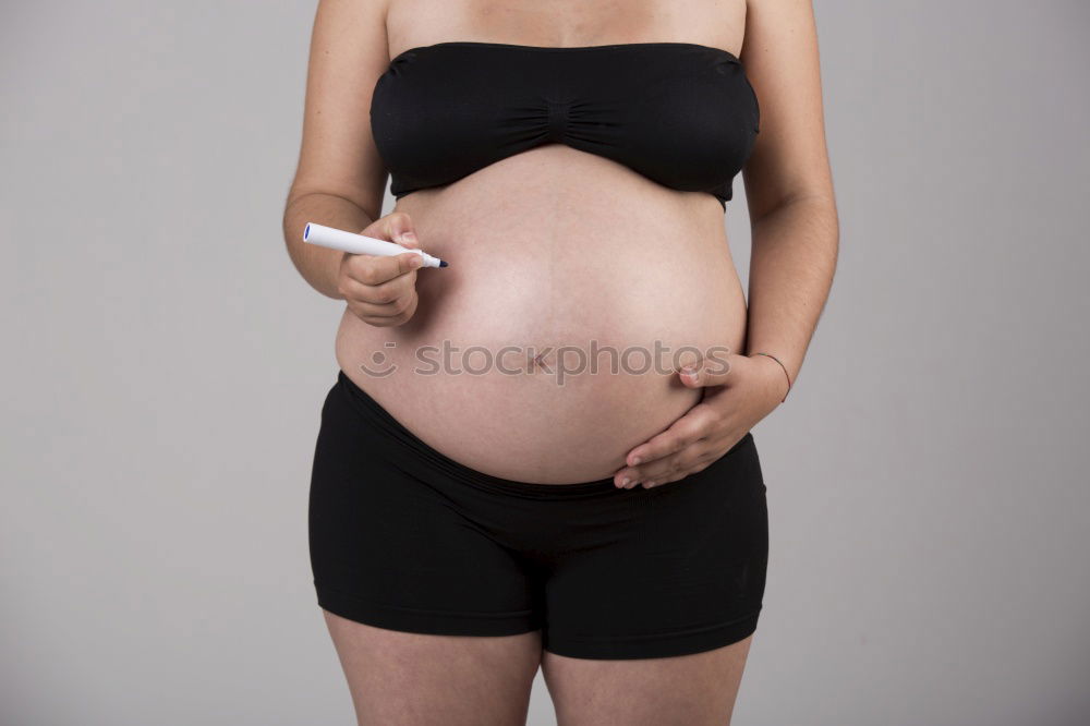 Who am I? Young woman holding a round mirror in front of her body. The mirror is showing her blurred face.