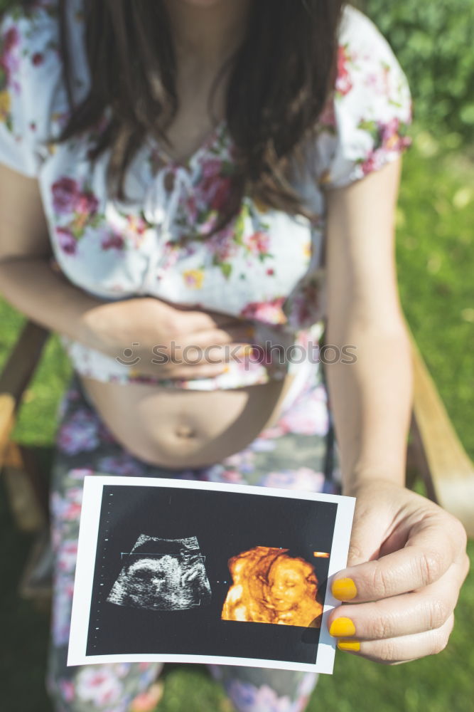 Similar – Image, Stock Photo pregnant woman sitting on the bench and loocking ultrasound scan at the day time. Concept of happy expectation.