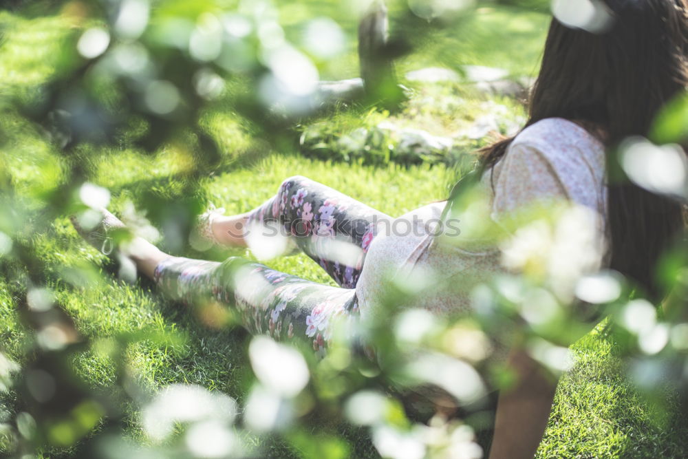 Similar – Winter ideas. Beautiful young girl stretching her finger upwards while snowing on a green meadow.