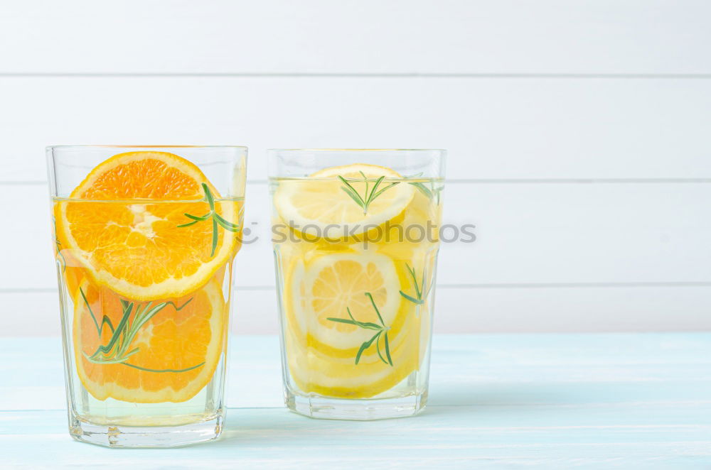 Similar – Cool soft drink with mineral water, tangerine, cucumber slices, ice cubes and green straw