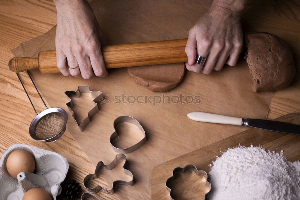 Similar – Cooking Christmas cookies with cookie cutters on a dark table