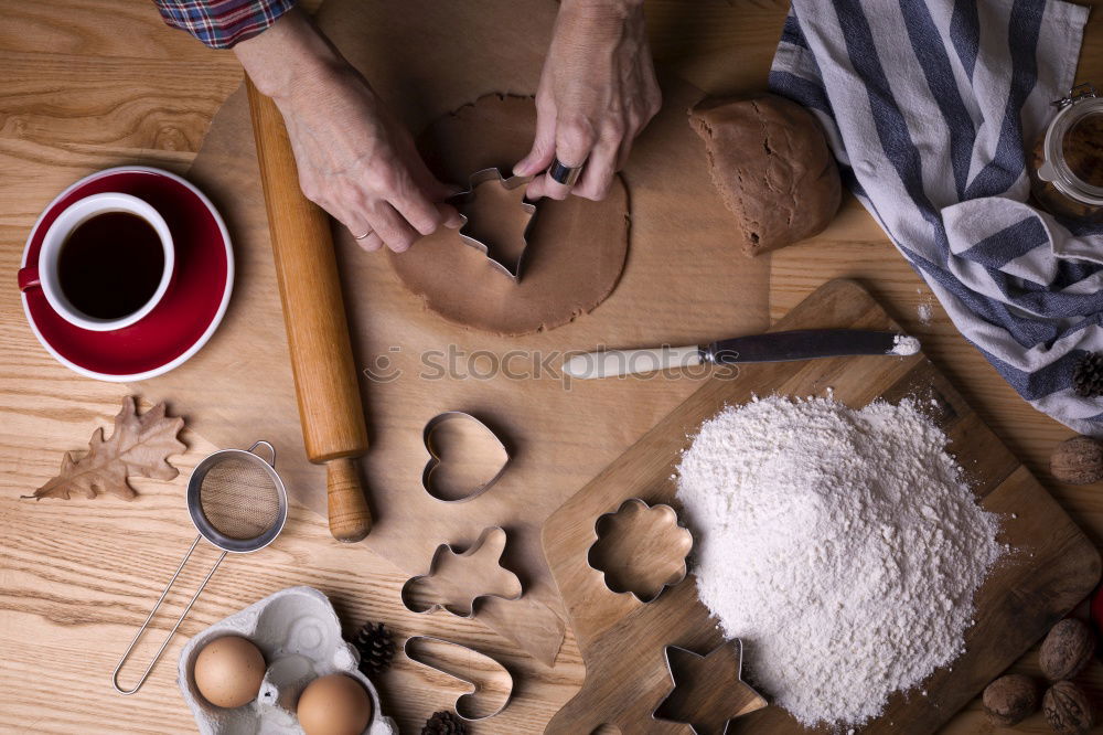 Similar – Image, Stock Photo Close up of cookie cutters and rolling pin on a dark table