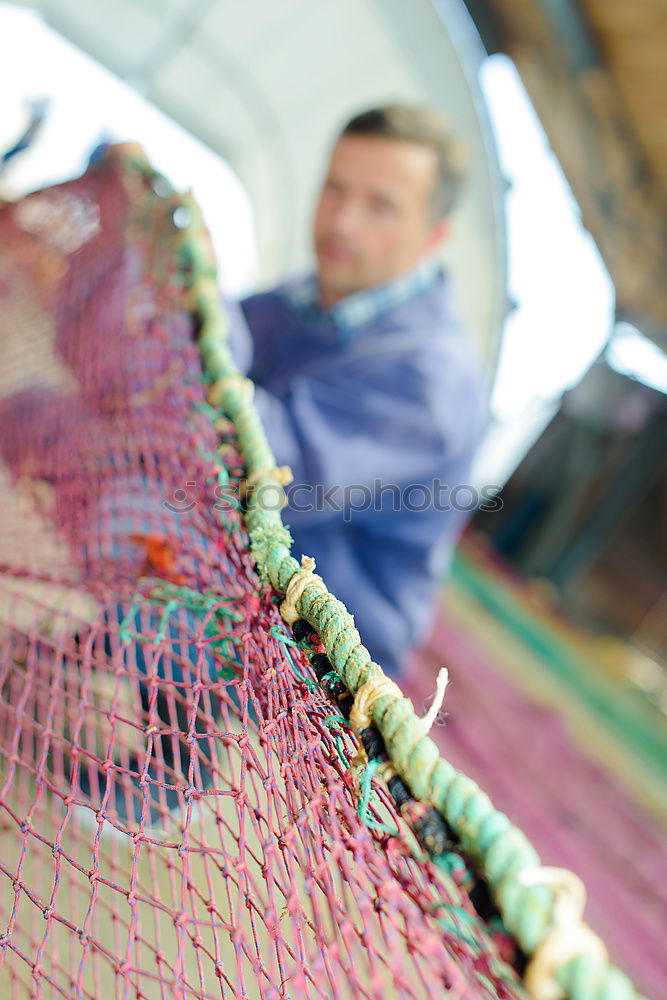 Similar – Image, Stock Photo Man working with fishing net