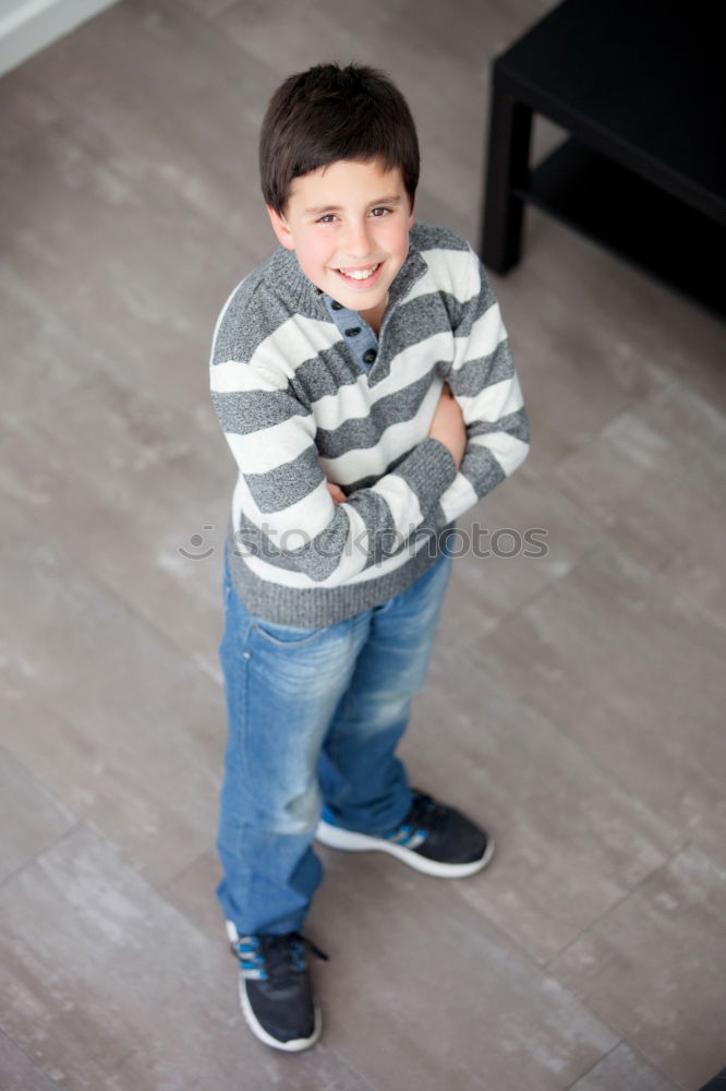 Similar – Little boy with a mibile phone with a wooden door background