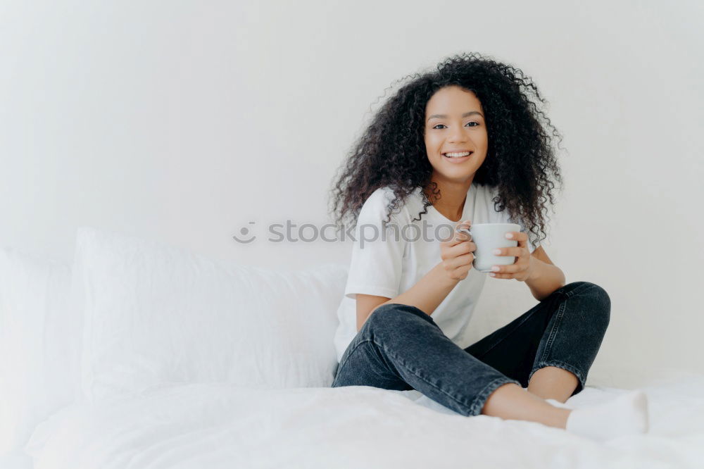 Similar – close up of a pretty black woman with curly hair smiling and lying on bed looking away