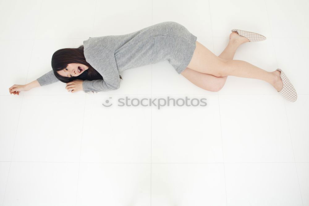 Similar – Image, Stock Photo Young, athletic, slender woman stands sideways in front of a white wall with her head bent forward so that her long brunette hair hangs down in front of her face
