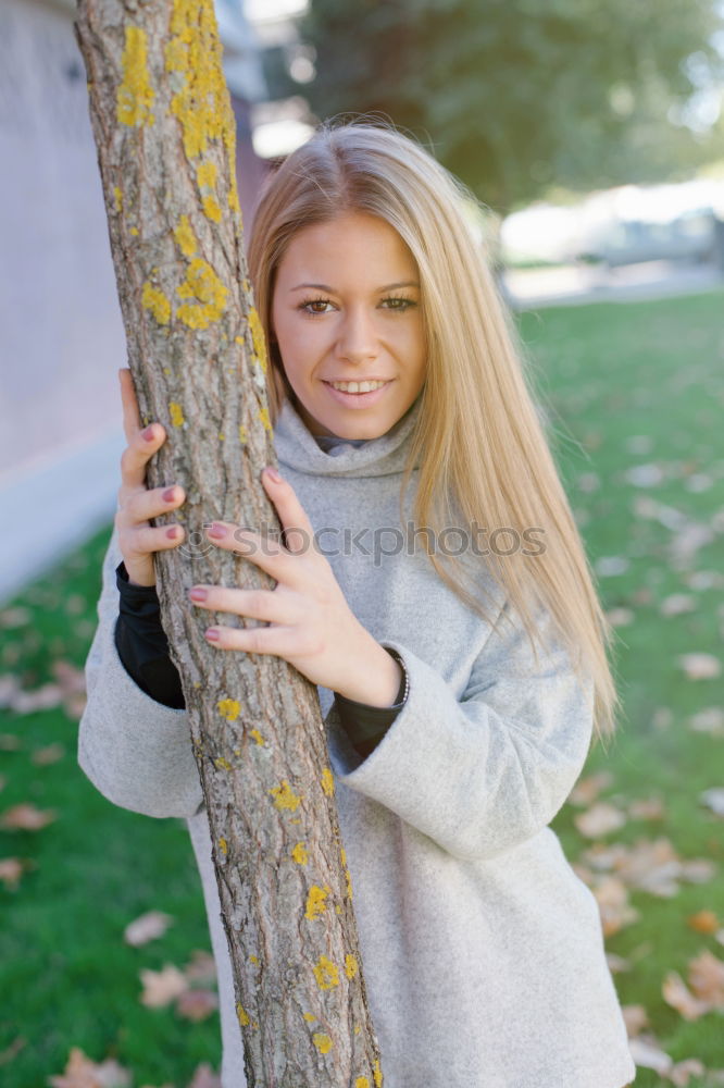 Similar – Young woman in grey sweater is standing in a clearing in the woods