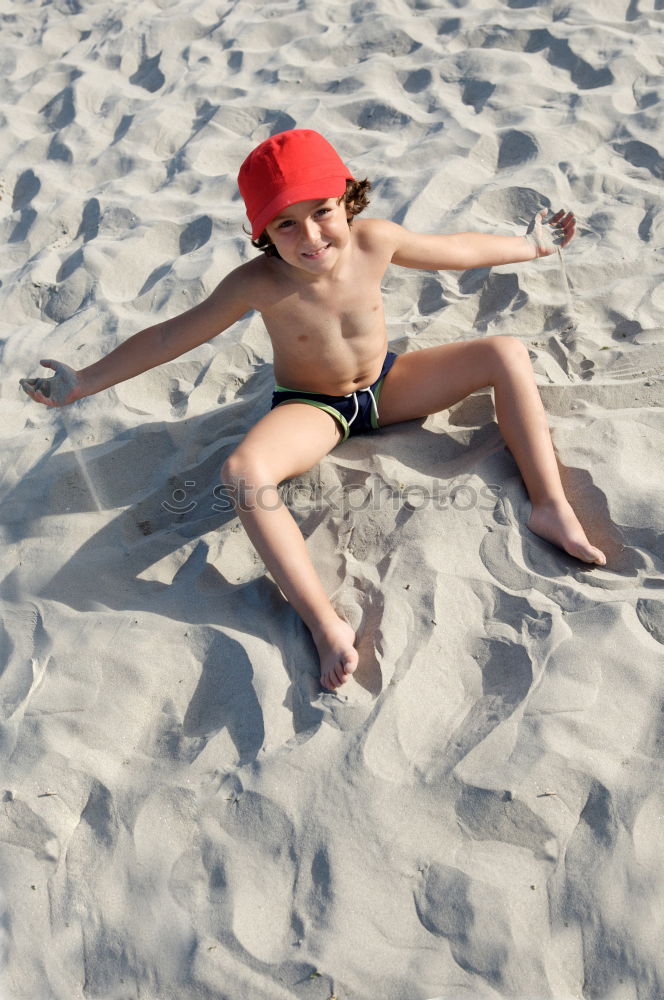 Similar – little girl stands on beach in a special swimsuit for children who can not swim. child in swimsuit, which he kept afloat