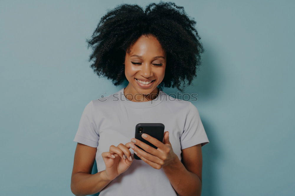 Similar – Image, Stock Photo Beautiful afro american woman using mobile in the street.