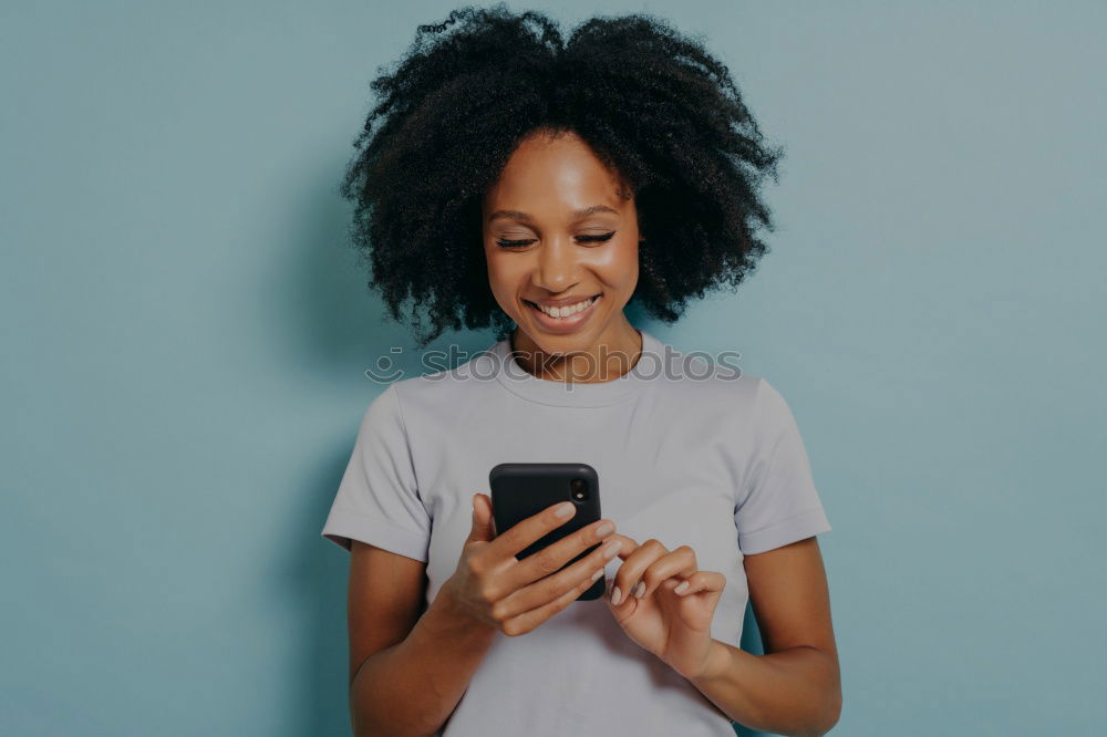 Image, Stock Photo Beautiful afro american woman using mobile in the street.