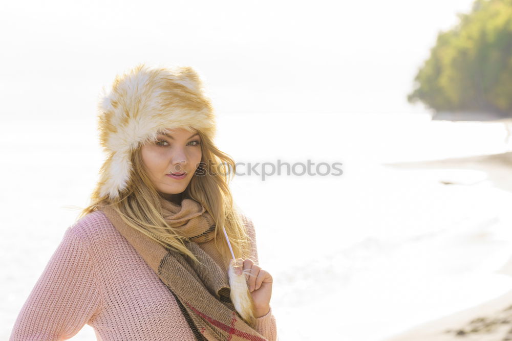 Similar – Young woman with a blue cap over her face