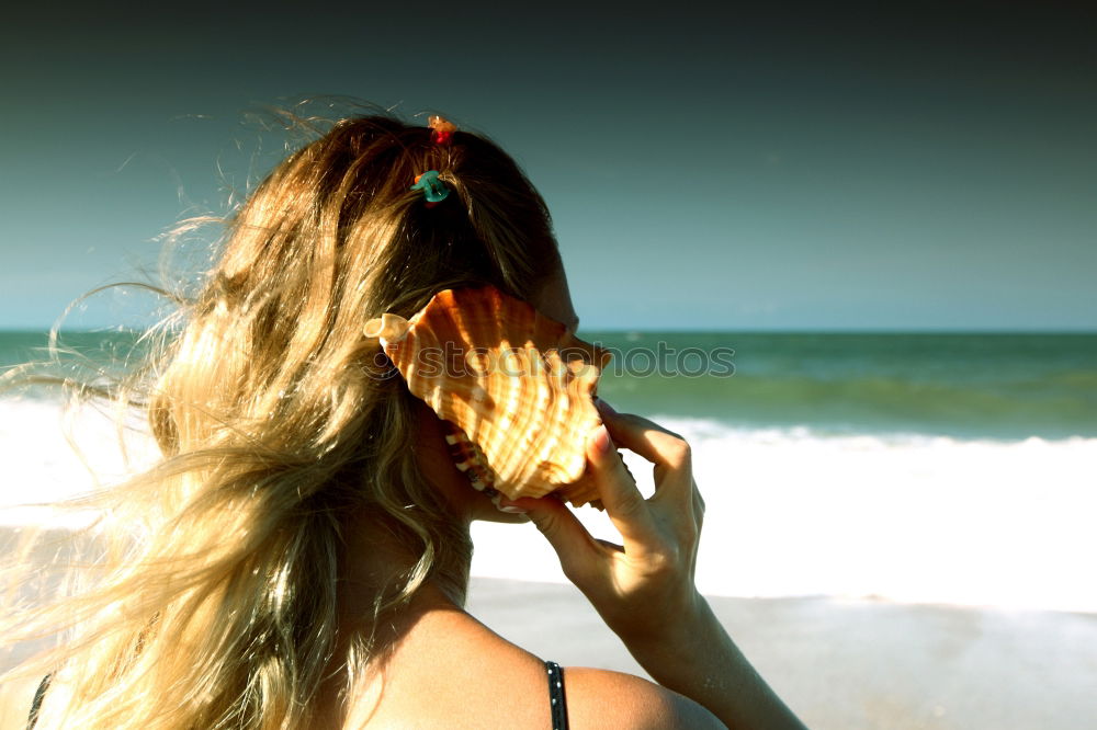 Similar – Young woman at the beach while the sunset smiling