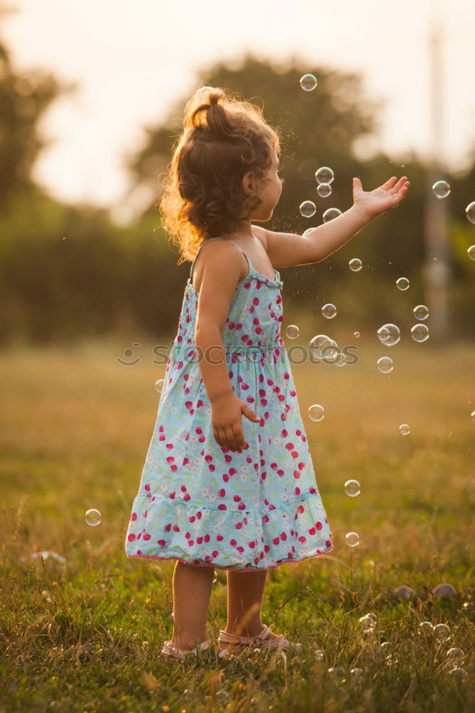 Similar – Image, Stock Photo Young girl with brown hair is playing outside.