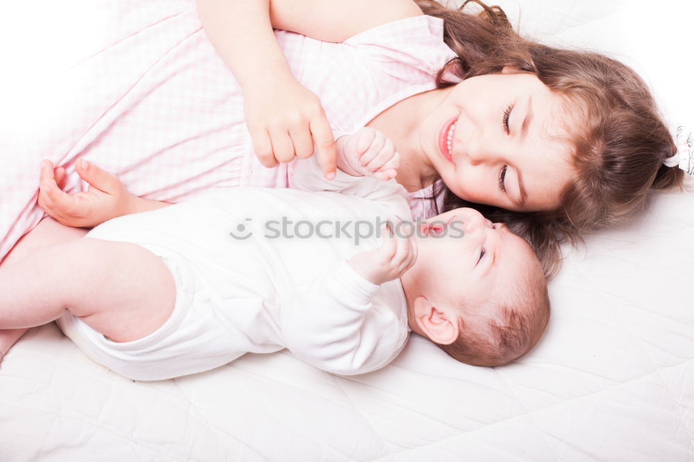 Similar – Woman playing with little happy baby on bed