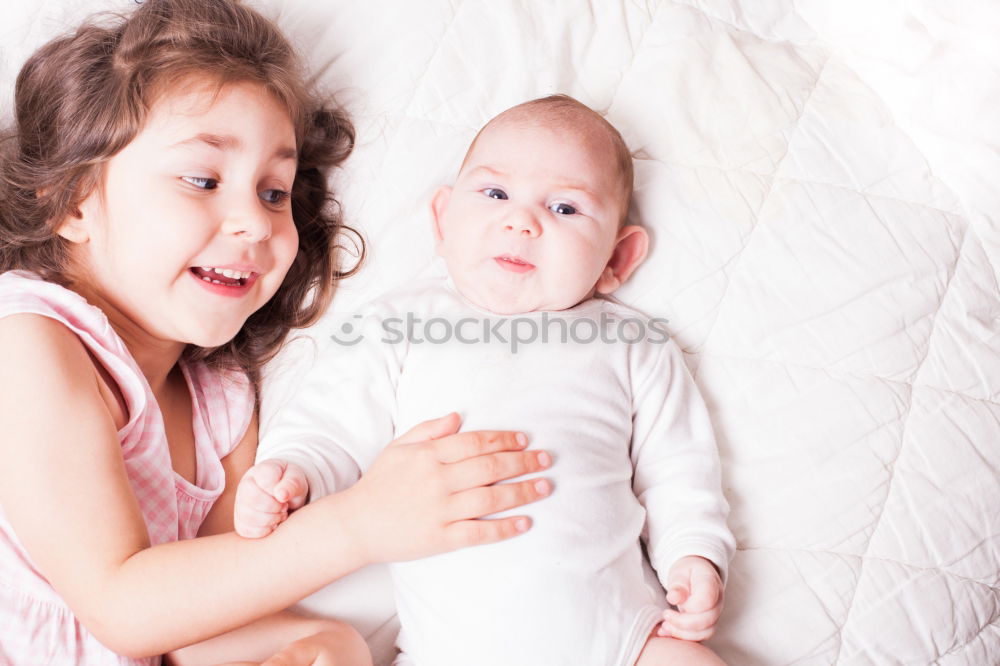 Similar – Two beautiful sisters playing on bed