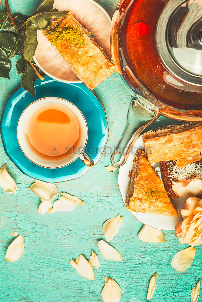 Similar – Tea brunch with coloured teacups, teapot and cake