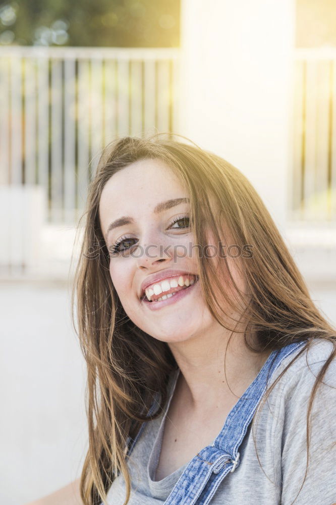 Similar – Young woman smiling in urban background