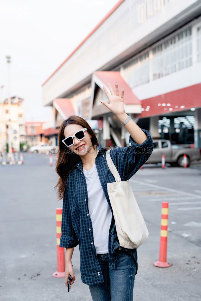 Similar – Image, Stock Photo Back view rear view of a woman holding shopping bags while wearing cool style cloths. Jeans and a top. Shopping street. Changing and buying gifts concept.