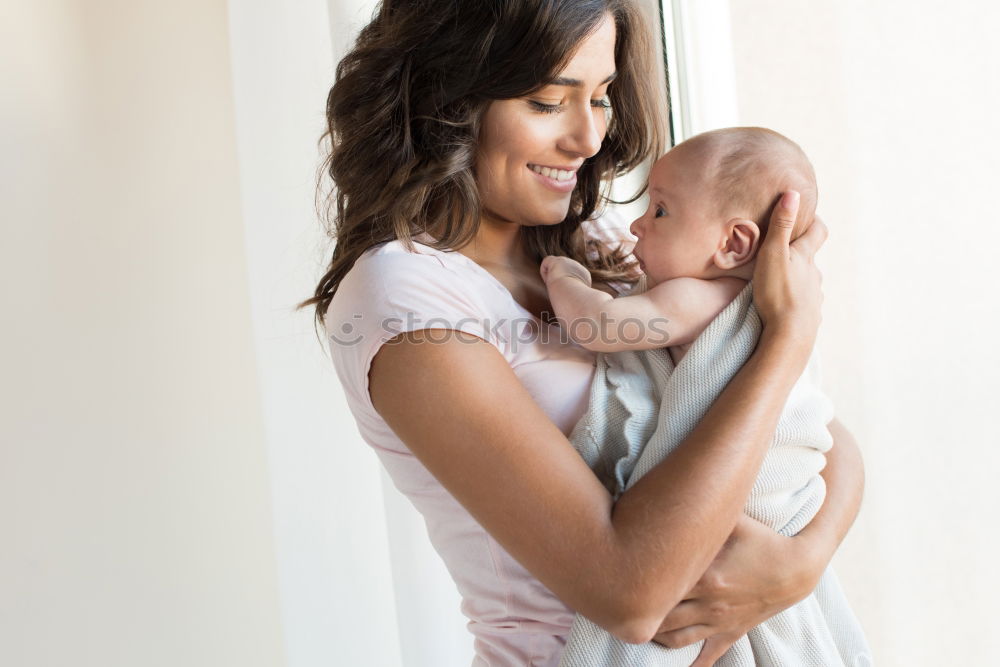 Similar – Image, Stock Photo Young mother holding her baby in the bedroom