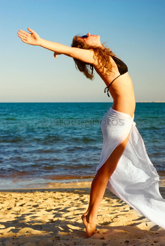 Similar – Woman enjoying the sunset on a beautiful beach