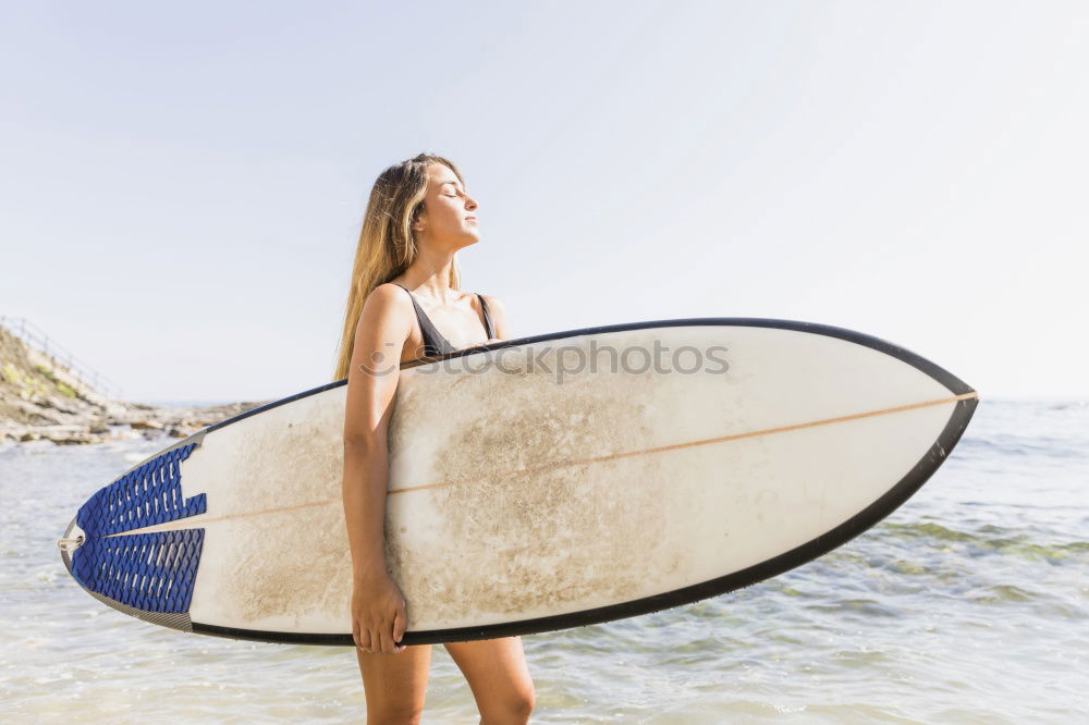 Similar – Image, Stock Photo Caucasian Girl holding surfboard on the beach