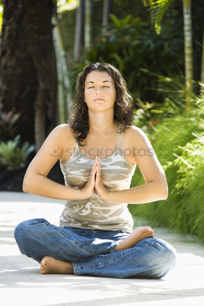 Similar – Young woman doing yoga in nature. Lotus figure.