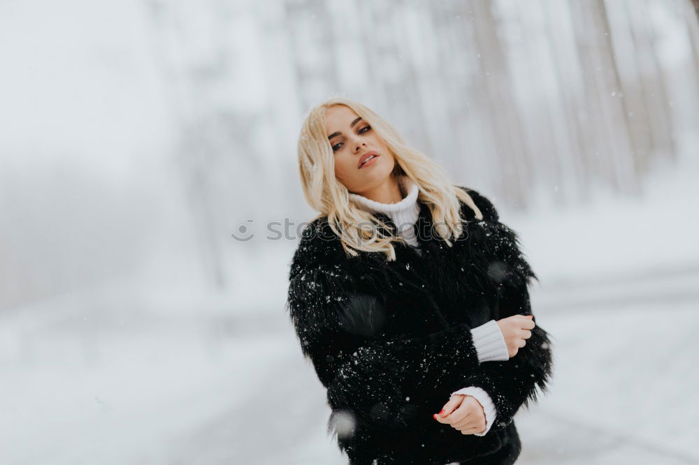 Similar – young woman 30 years in snow with red coat and leopard dress blond hair curly happy hopeful street