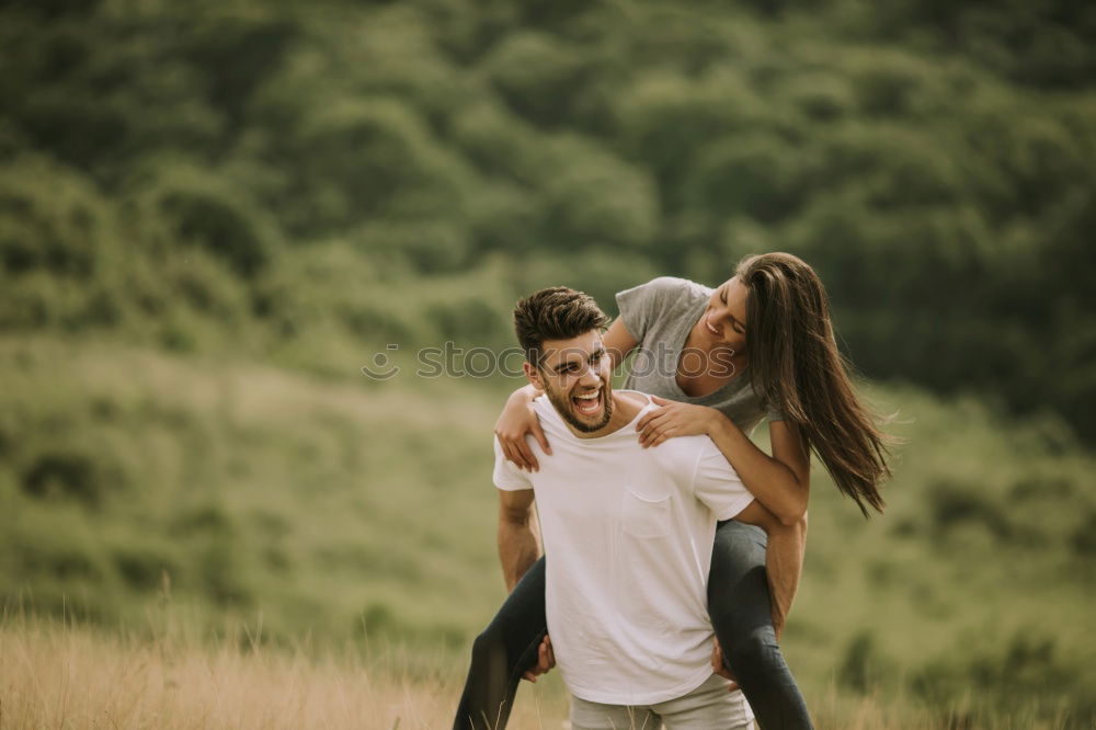 Similar – Image, Stock Photo Happy couple hugging and kissing near tree in park