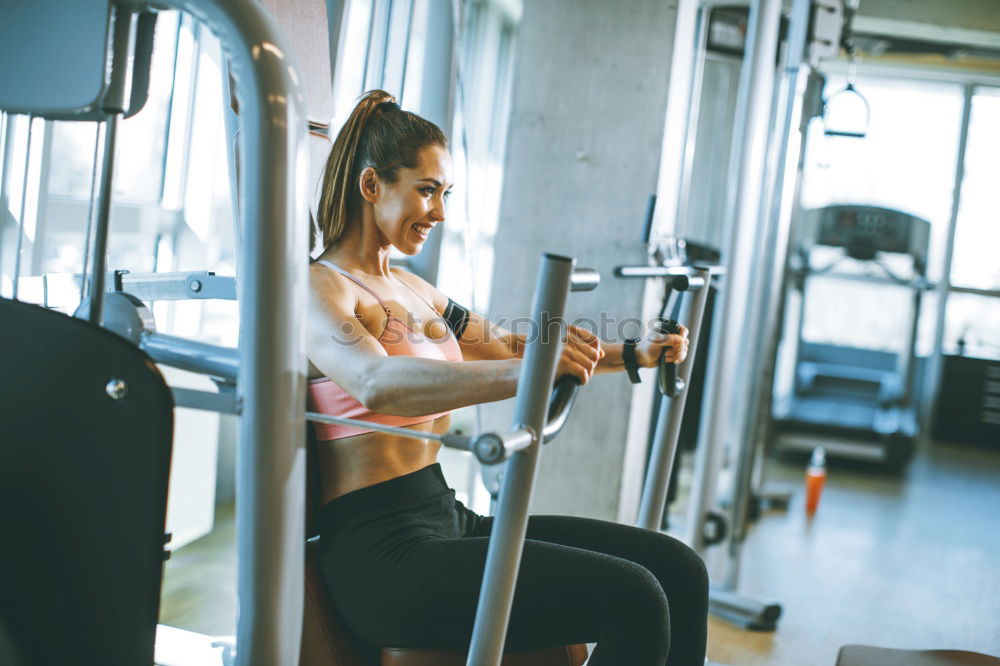 Woman training over treadmill on fitness center