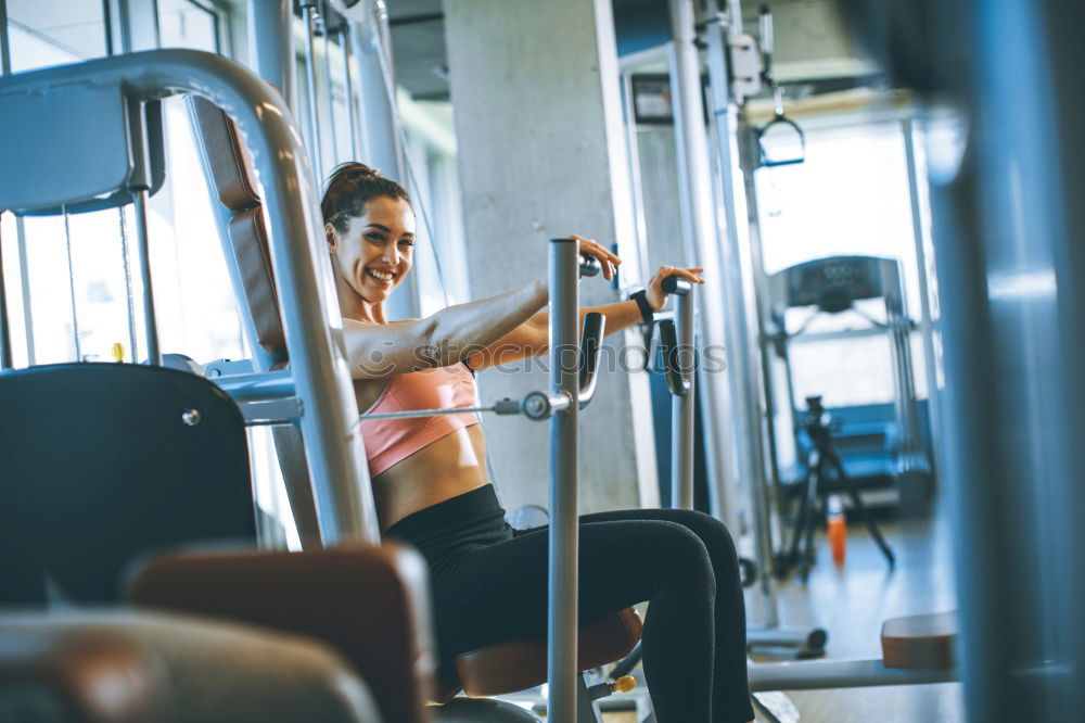 Similar – Sporty woman sitting with dumbbells and smartphone in gym floor