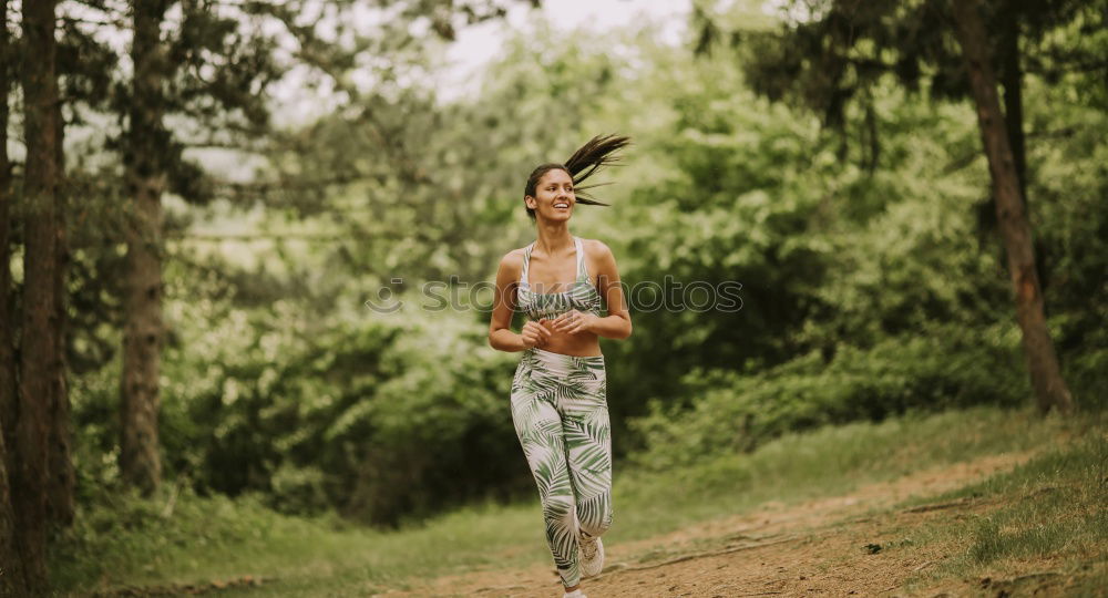 Similar – Image, Stock Photo Athletic woman out jogging in a forest