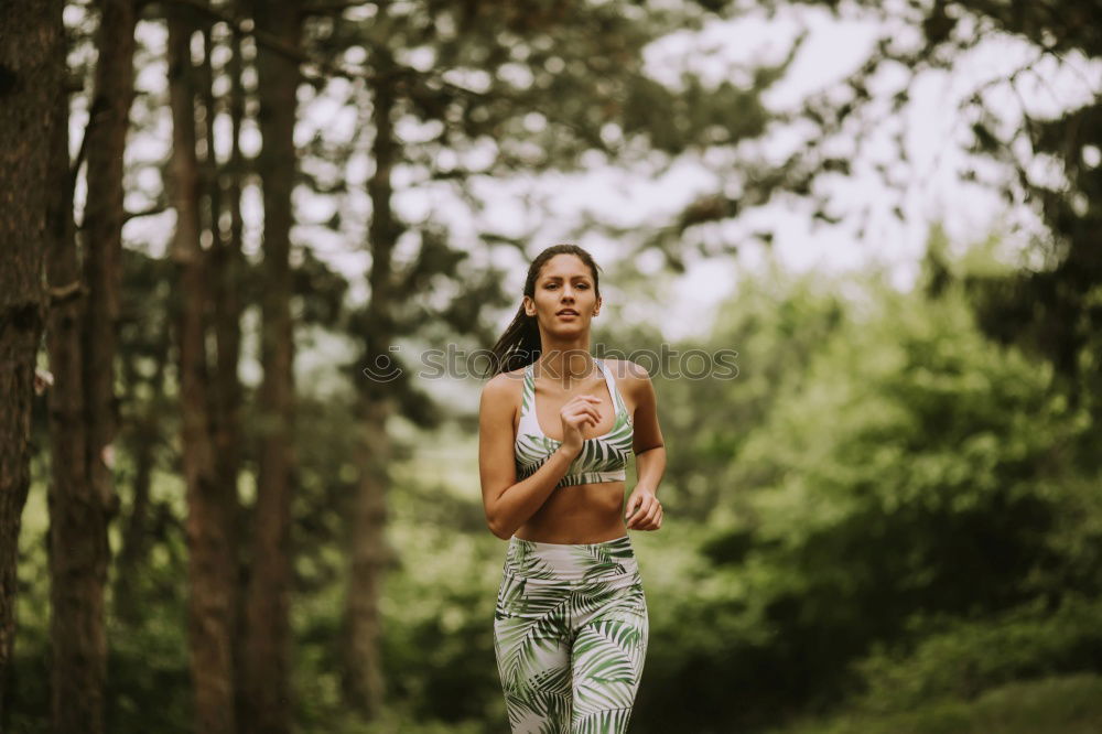 Image, Stock Photo Athletic woman out jogging in a forest